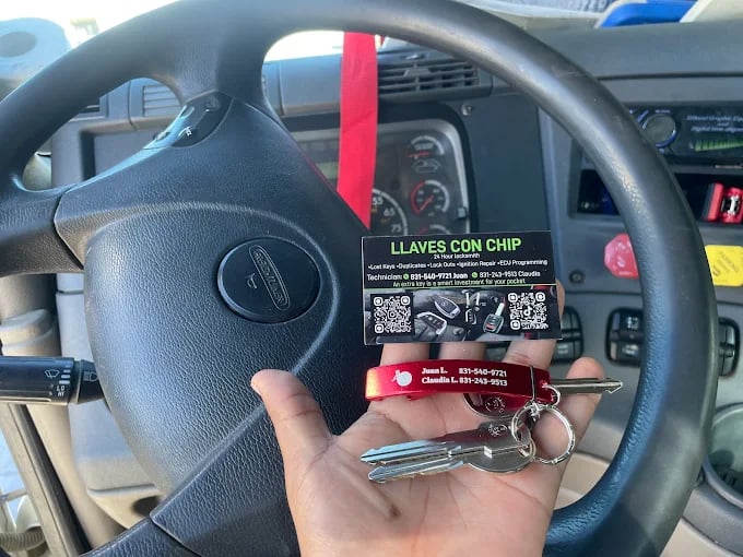 Hand holding car key and chip card inside vehicle dashboard