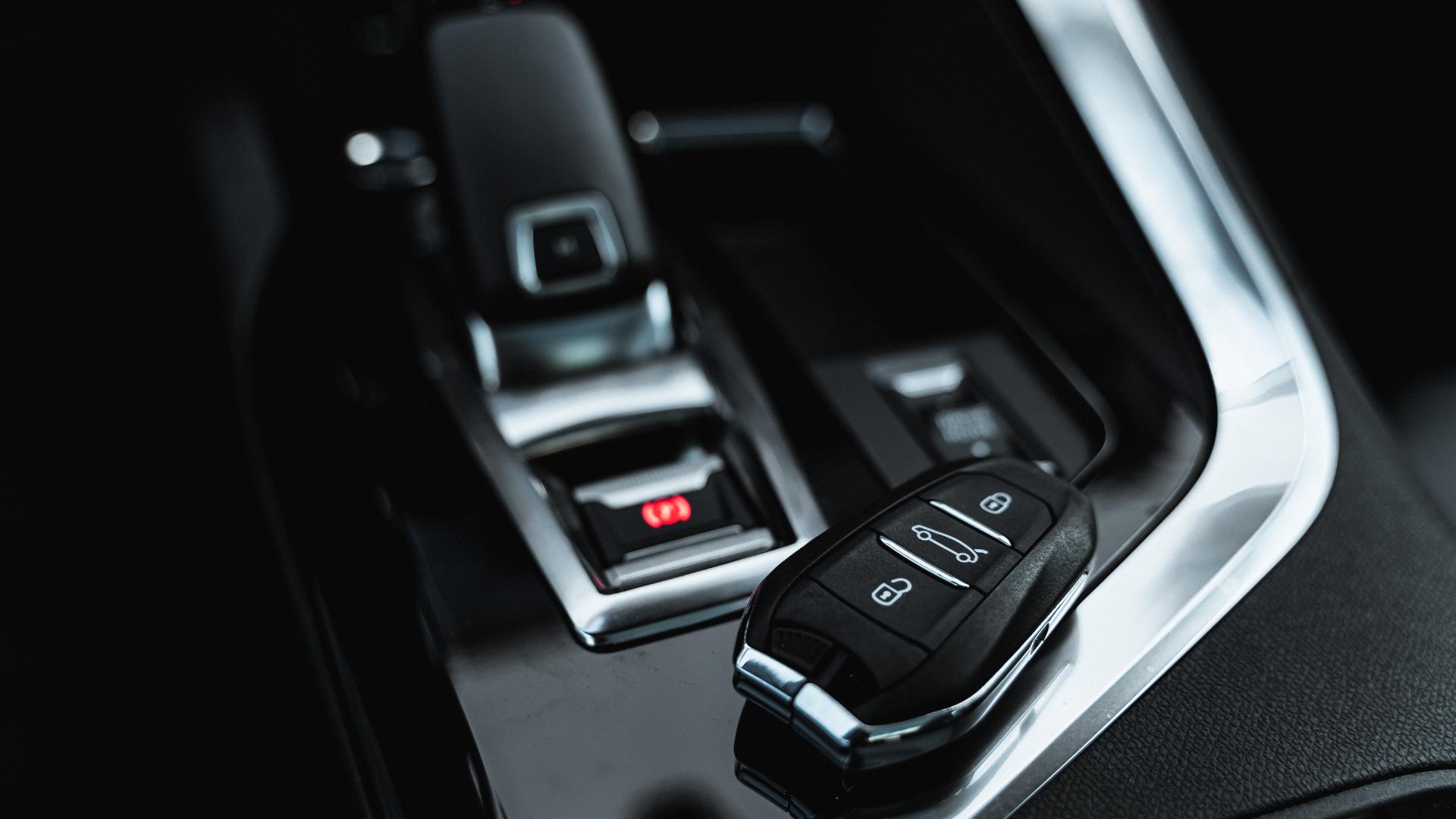 Smart key fob displayed on car dashboard — proximity programming complete