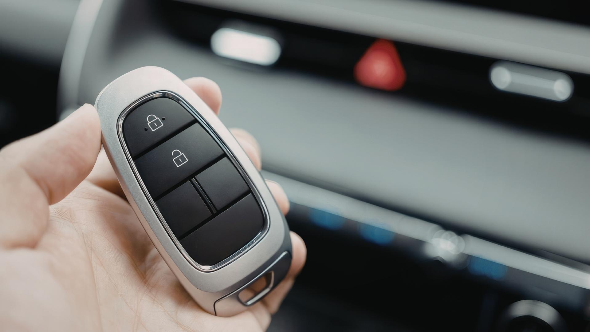 New car key fob with programming buttons inside a vehicle