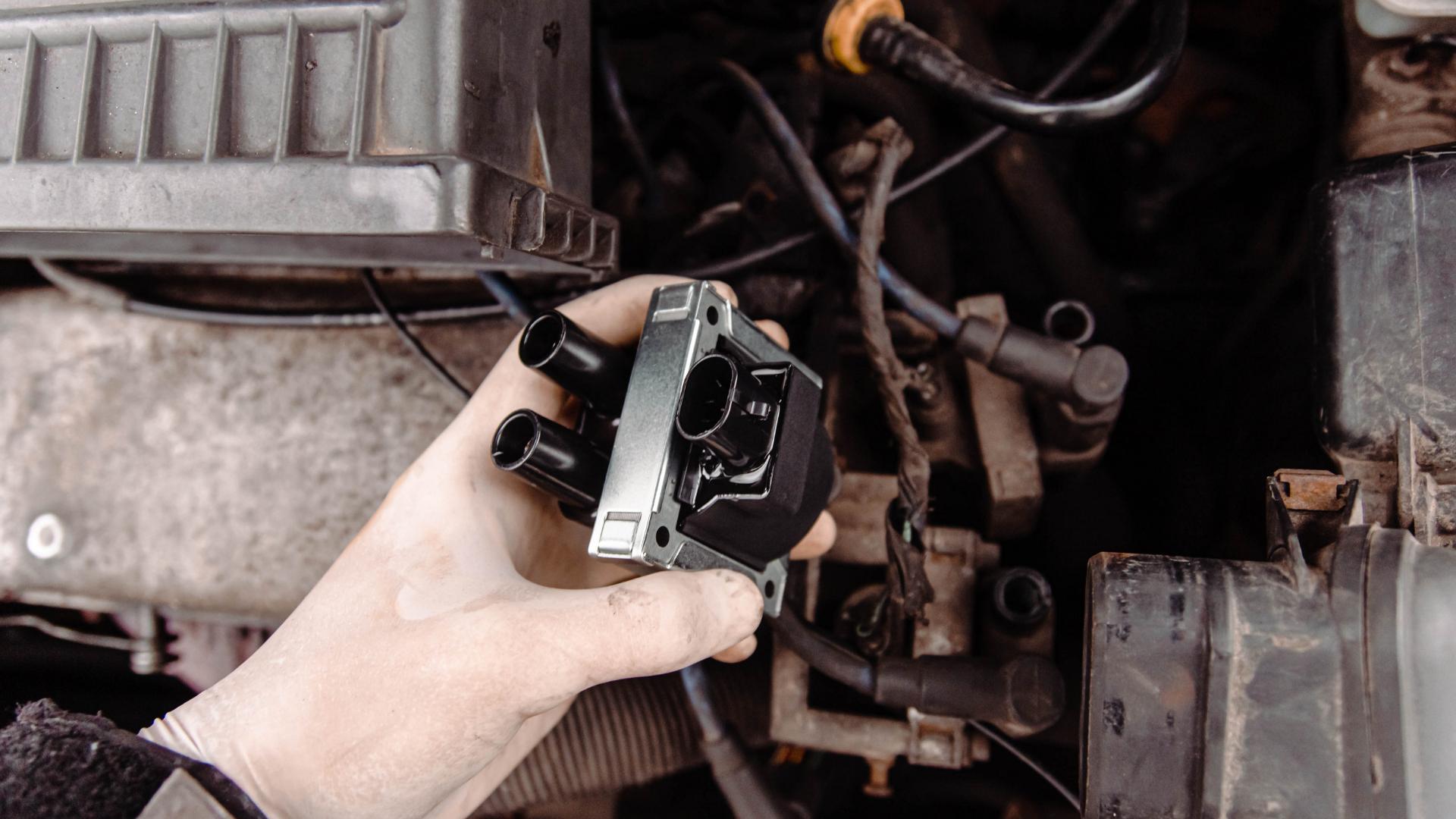 Ignition cylinder removed for repair on a vehicle engine bay