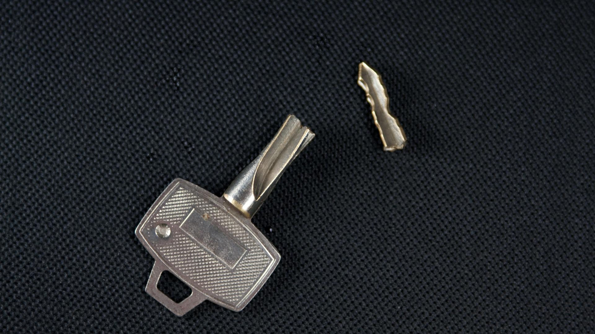 Broken car key pieces after professional extraction